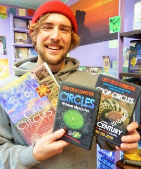 Tenzin Butt with some of the crop circle merchandise available in Central Tilba's Gulaga Gallery and Bookshop.