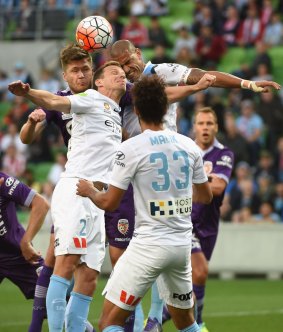 Jack Clisby and Patrick Kisnorbo, of Melbourne City, and Andy Keogh, of Perth Glory, contest a header during the A-League elimination final.