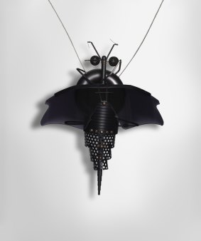 Susan Cohn
<i>Systematic Gibsonia no. 2</i>, condom pendant 1995 in Bodywork: Australian Jewellery 1972-2012 at Craft ACT 
anodised aluminium, Oakley black iridium sunglass lenses, Sony wind socks, 750 white gold, 925 silver, stainless steel, aluminium plate
National Gallery of Australia, Canberra
Purchased 1995