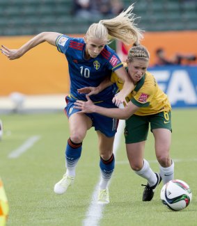 Australia's Elise Kellond-Knight and Sweden's Sofia Jakobsson race for the ball during their Women's World Cup clash in Edmonton on Tuesday. 