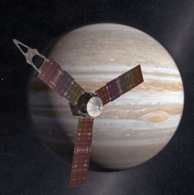 The Juno spacecraft passes in front of Jupiter in this artist's depiction. 