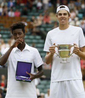 The long and the short of it: Opelka of the United States, right, holds the trophy after beating Mikael Ymer of Sweden.