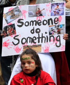 A young girl attends a pro-Palestine rally in Sydney's CBD on Sunday.