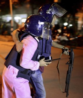 A member of Bangladeshi security personnel is taken for medical attention after gunmen attacked a restaurant  in a diplomatic zone of the country's capital Dhaka.