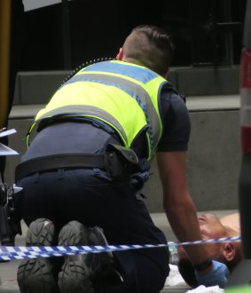 Police attend to Dimitrious Gargasoulas after his alleged driving rampage through Bourke street Melbourne.