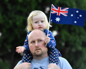 Family event: Steve Nathan and Scarlett, 2, watch Ivanhoe RSL's Anzac ceremony just days after a fire gutted the local club house.