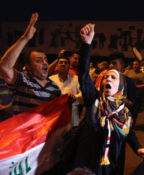 Iraqis celebrate in the capital, Baghdad, on Sunday as they wait for the final announcement of victory in Mosul. 