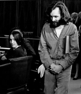 Charles Manson walks into the courtroom in October 1970  as Susan Atkins, a member of his family of followers, looks on.
