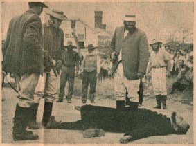 Scan of photo from <i>The Canberra Times</i> of the re-enactment at the 100th anniversary of the shooting of Constable Nelson (played by Edgar Penzig) by bushranger John Dunn (played by Chris Woodland) on January 26, 1965. (Photo: Courtesy Chris Woodland) 
 

Collector re-enactment 2 CT.jpg
