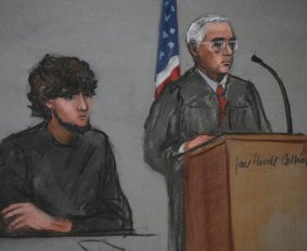 A courtroom sketch shows accused Boston Marathon bomber Dzhokhar Tsarnaev next to Judge George O'Toole on the first day of jury selection at the federal courthouse in Boston.