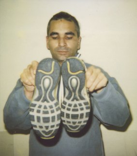 Prisoner Ali Ali with bloodstained shoes, in 1999.
