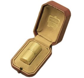 Made by Dunhill for Cartier. A tiny cylindrical model in gold about the same size as a lipstick, designed for ladies.