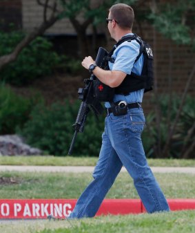 An officer works at a shooting scene on the North Lake College campus in Dallas.