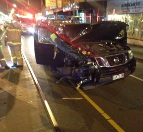 The black Nissan ute was extensively damaged in the collision.