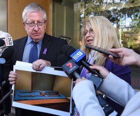Mark and Faye Leveson holding photos of their son's skeletal remains.