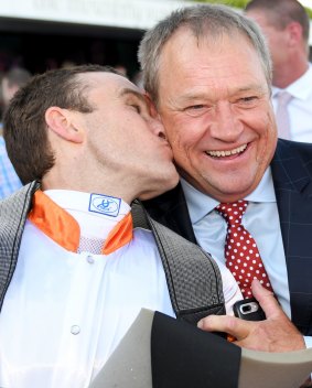 Tony McEvoy is kissed by Luke Currie after their Australian Guineas success.