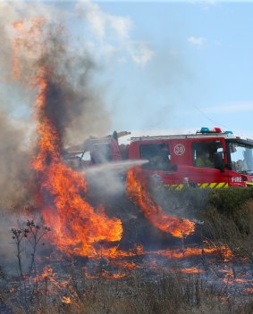 Firefighters tackle a fast moving grass fire near Epping, in the northern suburbs of Melbourne, in December 2015. 