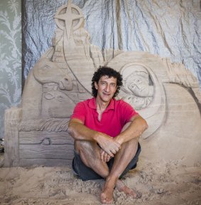 Peter Papamanolis, a Brisbane-based sand sculptor with the Greek nativity scene he created at the The Greek Club in Brisbane.