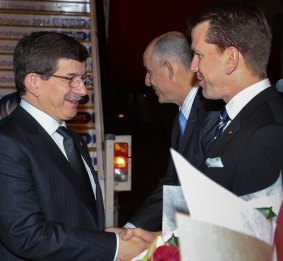 Turkey's Prime Minister Ahmet Davutoglu shakes hands with Queensland's Attorney-General Jarrod Bleijie upon arrival at the G20 Terminal in Brisbane.