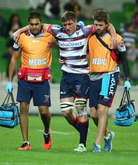 Sean McMahon of the Rebels leaves the field with an injury on Saturday.