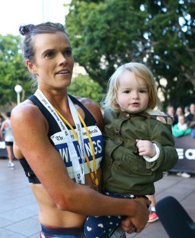 Eloise Wellings smiles with daughter India after winning the half-marathon.