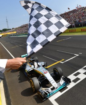 Line honours: Mercedes AMG Petronas F1 Team's Lewis Hamilton crosses takes the checkered flag.