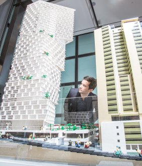 Then and now. Architect Fred Holt, from 3XN Architects in Copenhagen, inspects a Lego model of the new AMP building his firm designed next to the current headquarters at a display at the Sydney Museum. 