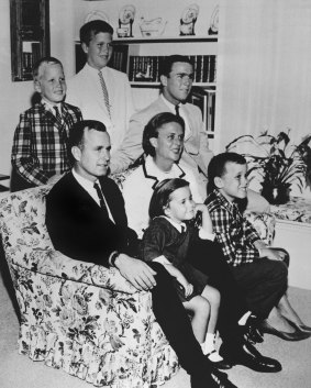 The Bush family in 1964. George H.W. Bush sits on couch with his wife Barbara and their children. George W. Bush sits at right behind his mother. Behind the couch are Neil and Jeb Bush. 