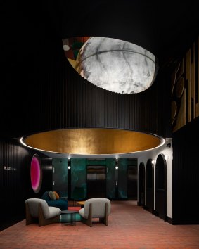 Guests are ushered into a terracotta tiled foyer with LED mirrored walls, a moon suspended from the ceiling.