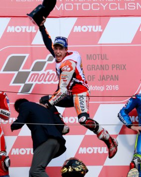 Full throttle: Spain's Marc Marquez jumps for joy after securing the 2016 MotoGP world title.