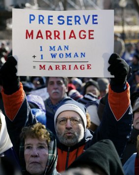 Southern Baptist minister Louis LoBue of  Massachusetts holds up a sign showing how he defines marriage.