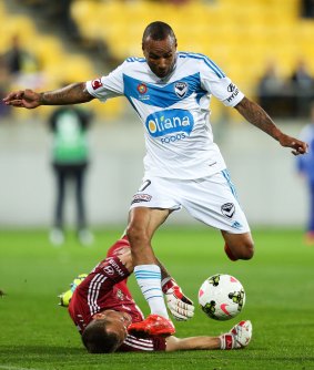 Decisive: Archie Thompson of the Melbourne Victory gets past Glen Moss of the Phoenix.