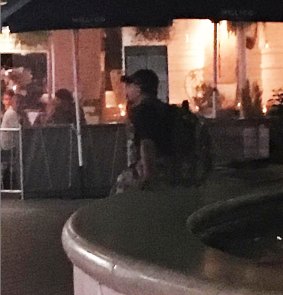 The alleged offender sits on the edge of the fountain in the Westfield Hornsby forecourt.