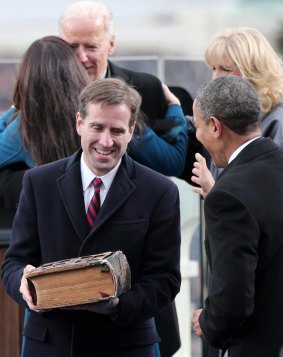 Beau Biden, carries the family Bible after his father was sworn in as US vice-president for the second time in January 2013.