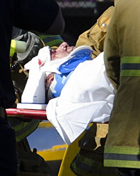 Paramedics attend to Harrison Ford, who was left with head injuries after the plane crash. 