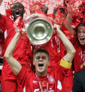 Gerrard holds the Champions League trophy aloft 10 years ago.