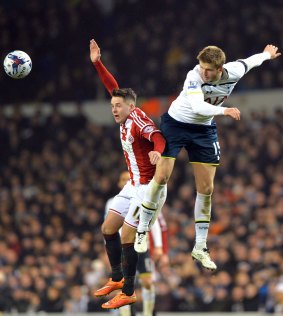 Eric Dier, right, competes with Marc McNulty.