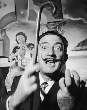 Salvador Dali in London with one of his paintings entitled The Madonna of Port Lligat.