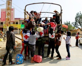 Volunteer rescue workers pick up people who have been displaced by recent violence, in Laukkai, Kokang. 