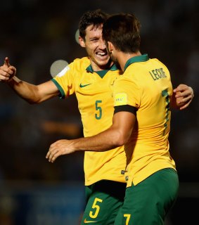 Mark Milligan celebrates with Leckie after scoring Australia's first goal.