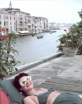 Guggenheim sunbathing on the terrace of her Palace on the Grand Canal, 1953. 