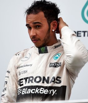 Cooled down: Hamilton on the podium after being beaten by Sebastian Vettel.