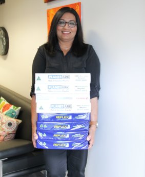 Greens MP Mehreen Faruqi with the number of pages it would take to print the 107,000 names on the petition.