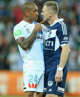 Patrick Kisnorbo and Besart Berisha get close and personal last season in the Melbourne Derby.