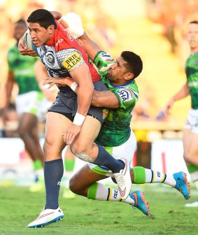 Jason Taumalolo of the Cowboys is tackled by Sia Soliola.
