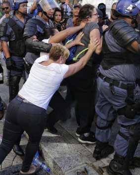 Protesting university students clash with riot police outside the National Assembly in Cape Town, South Africa.