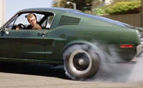 Steve McQueen driving a Ford Mustang in <i>Bullitt</i> (1968).
