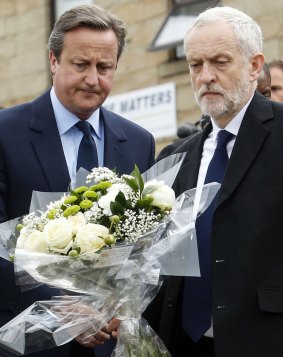 Britain's Prime Minister David Cameron, left, and Labour Party leader Jeremy Corbyn lay floral tributes in Birstall, northern England, for Jo Cox.