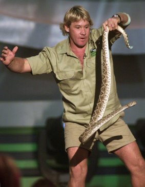 Steve Irwin in full flight holding a rattlesnake.