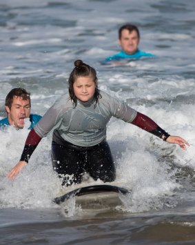Isabella says learning to surf with not-for-profit group Ocean Mind has given her more confidence. 